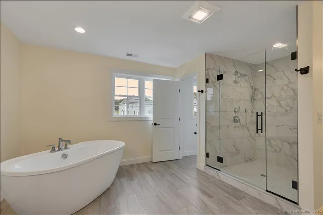 a bathroom with a bathtub and shower