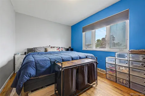 a bedroom with a bed and cabinet