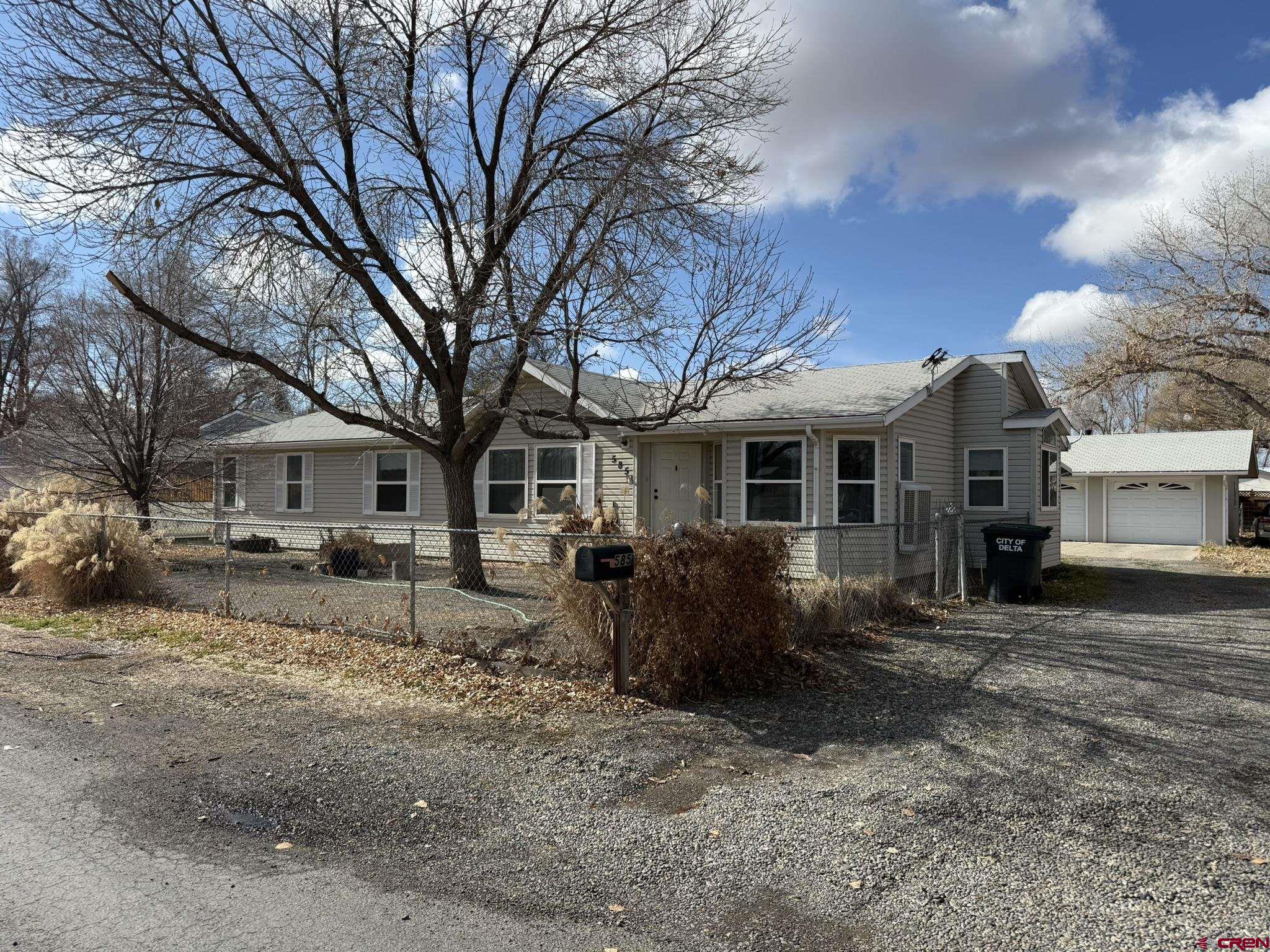 585 Elizabeth Street Delta, CO 81416 - Photo 1 of 36 a house that has a tree in front of it
