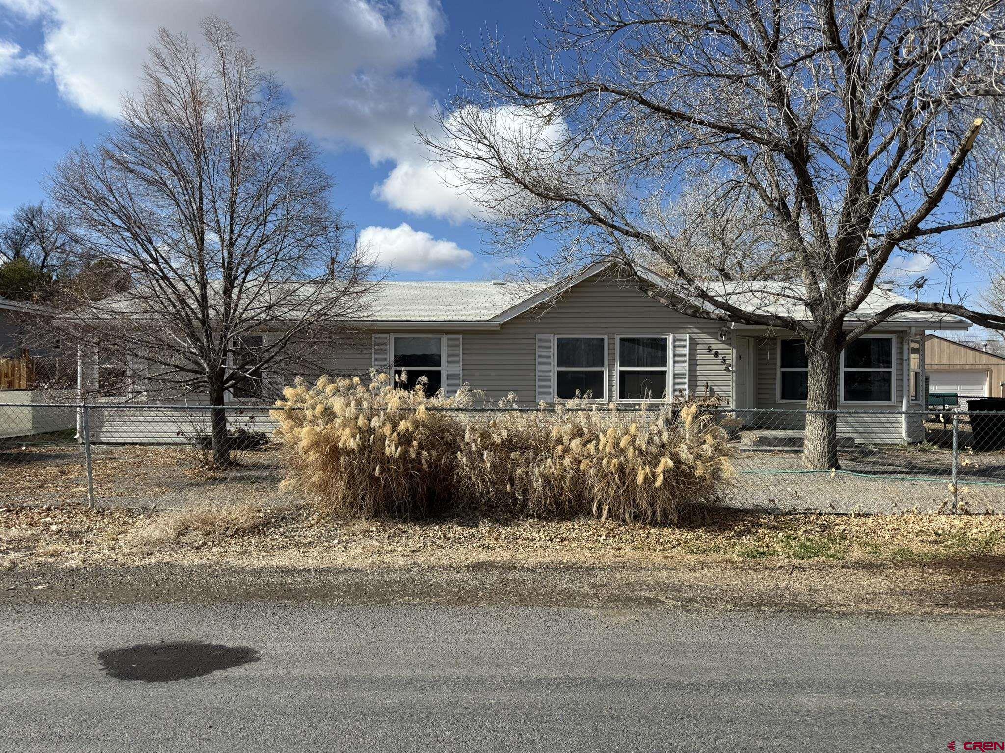 585 Elizabeth Street Delta, CO 81416 - Photo 14 of 36 a front view of a house with a yard
