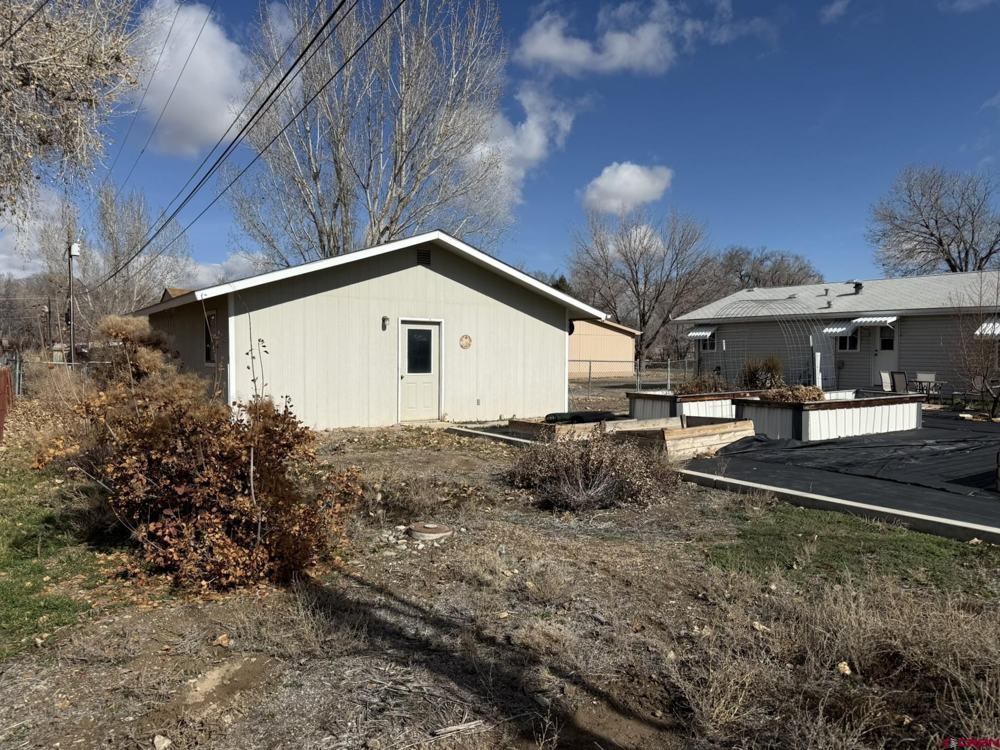585 Elizabeth Street Delta, CO 81416 - Photo 15 of 36 a front view of a house with garden and patio