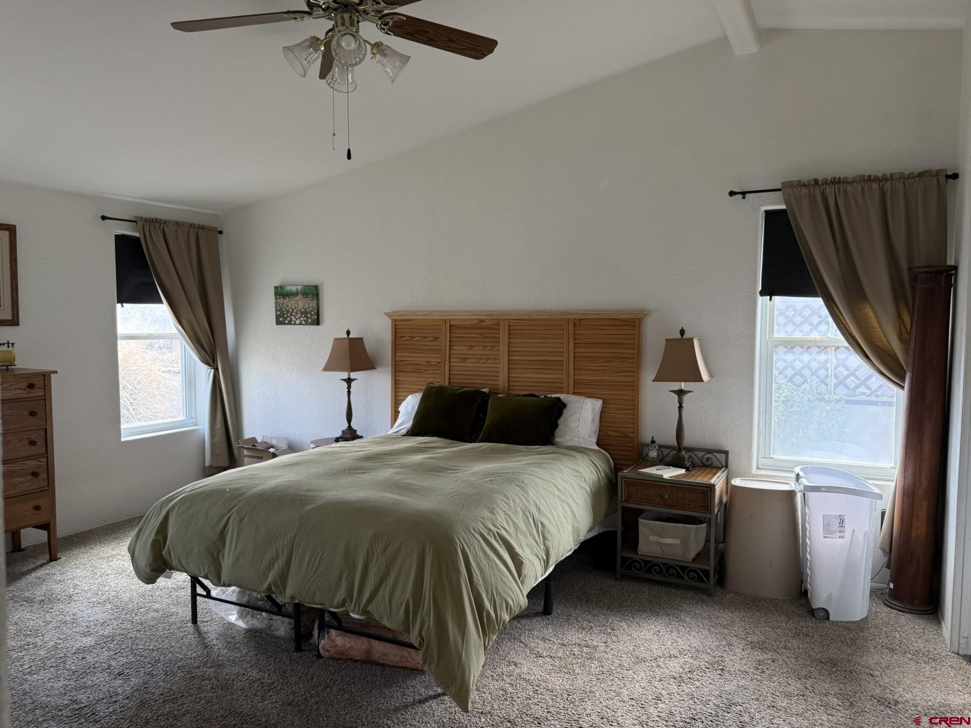 585 Elizabeth Street Delta, CO 81416 - Photo 25 of 36 a bedroom with a bed next to a window with a flat screen tv