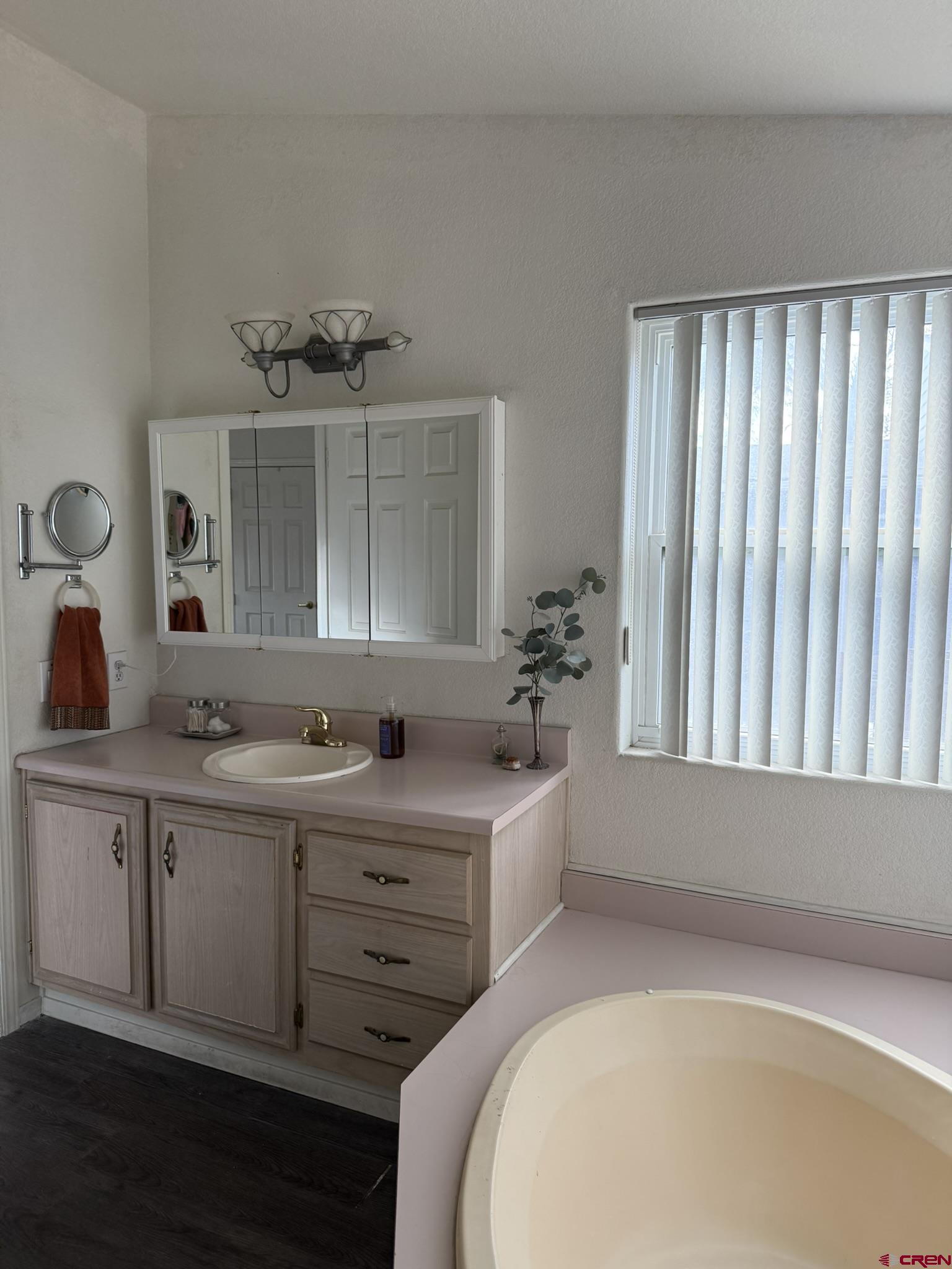 585 Elizabeth Street Delta, CO 81416 - Photo 26 of 36 a bathroom with a tub sink and mirror