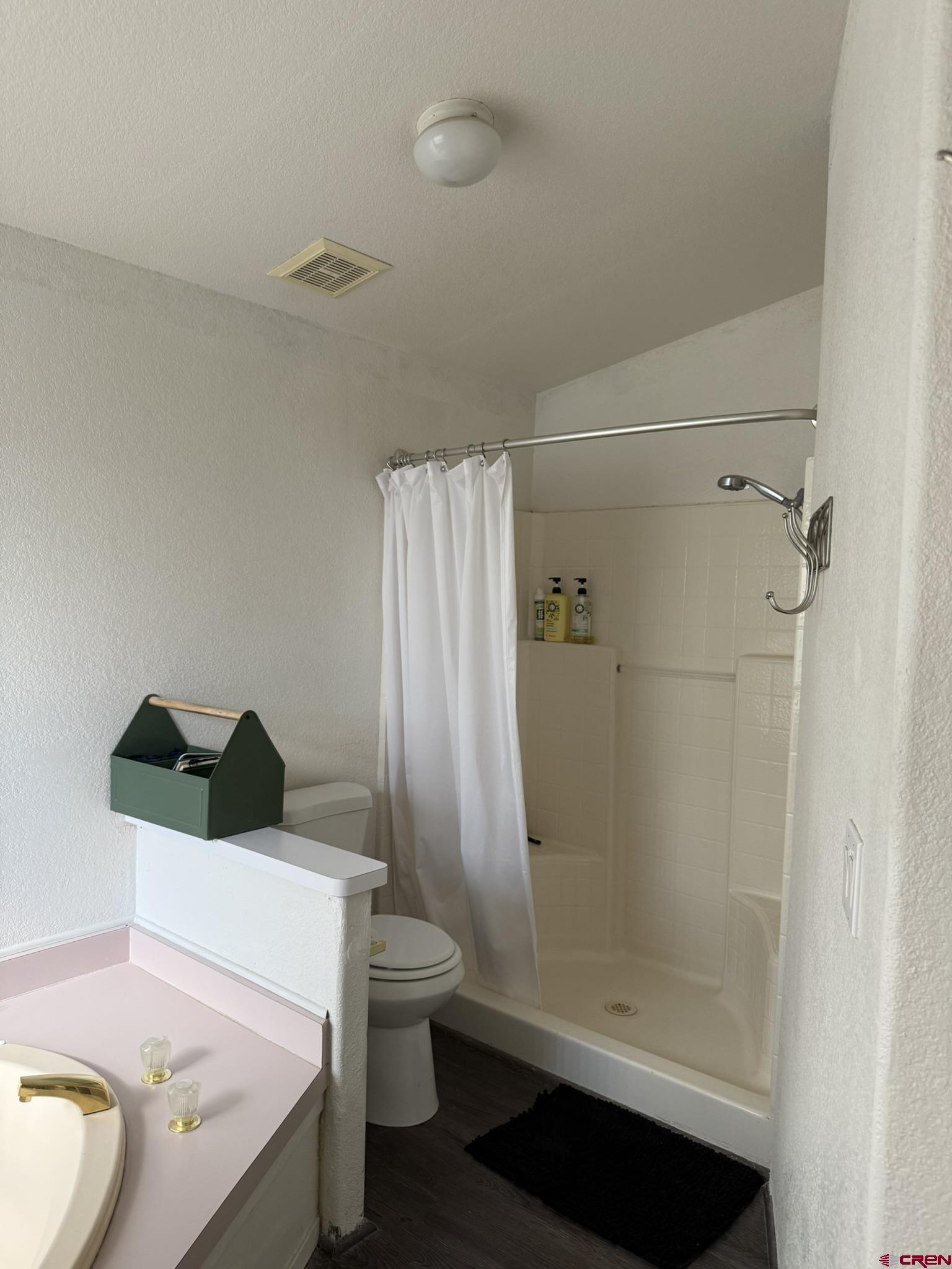 585 Elizabeth Street Delta, CO 81416 - Photo 27 of 36 a bathroom with a sink a toilet and shower
