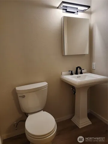 a white toilet sitting next to a bathroom sink