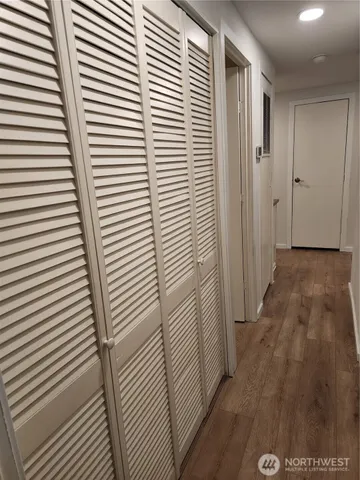 a view of a room with wooden floor