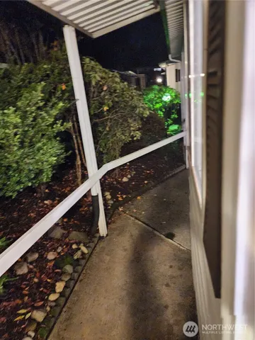 a view of a street with a bench and trees