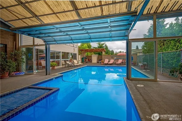 a view of house with swimming pool and porch