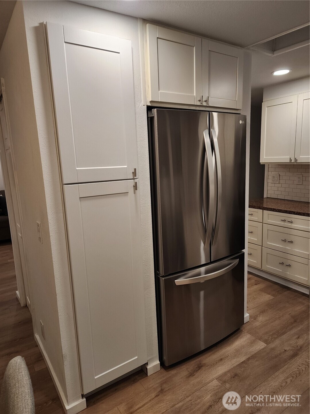 201 Union Avenue Southeast, Unit 43 Renton, WA 98059 - Photo 6 of 34 a view of a refrigerator in kitchen and white cabinets