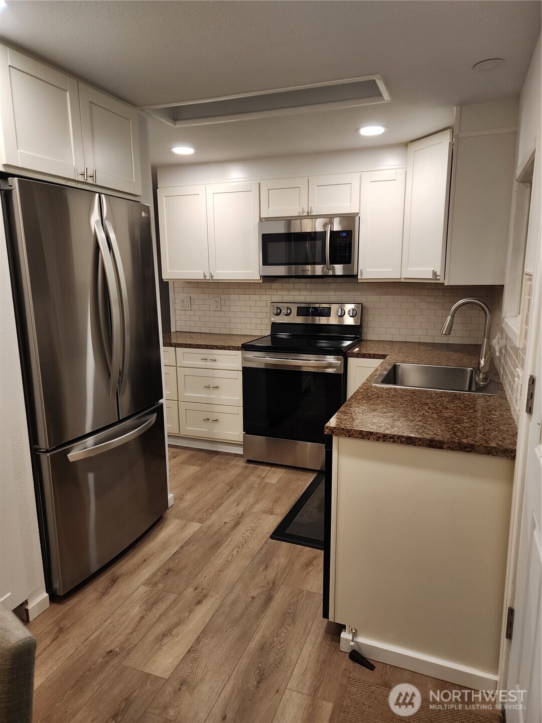 201 Union Avenue Southeast, Unit 43 Renton, WA 98059 - Photo 7 of 34 a kitchen with stainless steel appliances granite countertop a refrigerator stove and microwave