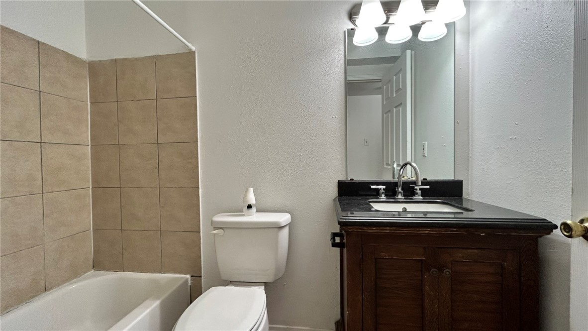 1004 Austin Street, Unit 2 Portland, TX 78374 - Photo 15 of 22 a bathroom with a sink a toilet and shower