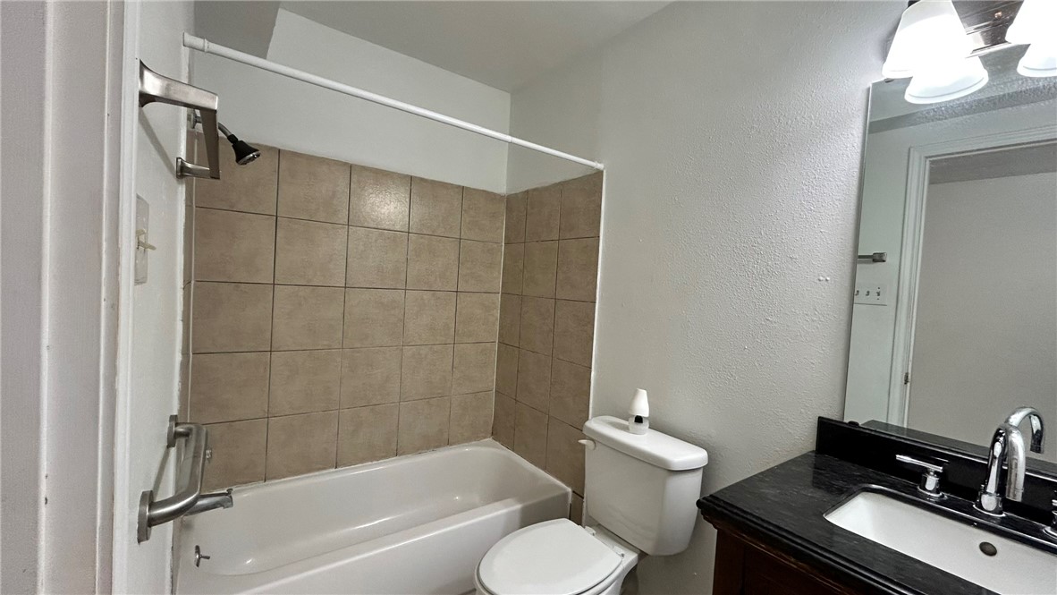1004 Austin Street, Unit 2 Portland, TX 78374 - Photo 16 of 22 a bathroom with a sink toilet and shower