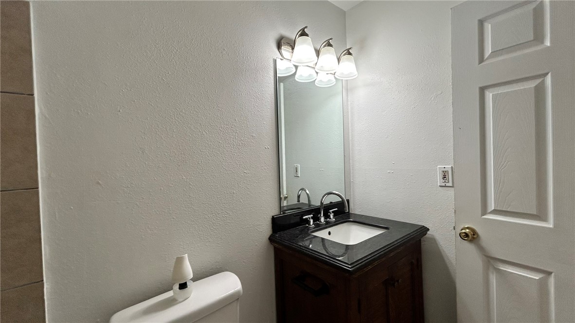1004 Austin Street, Unit 2 Portland, TX 78374 - Photo 17 of 22 a bathroom with a sink vanity and a mirror