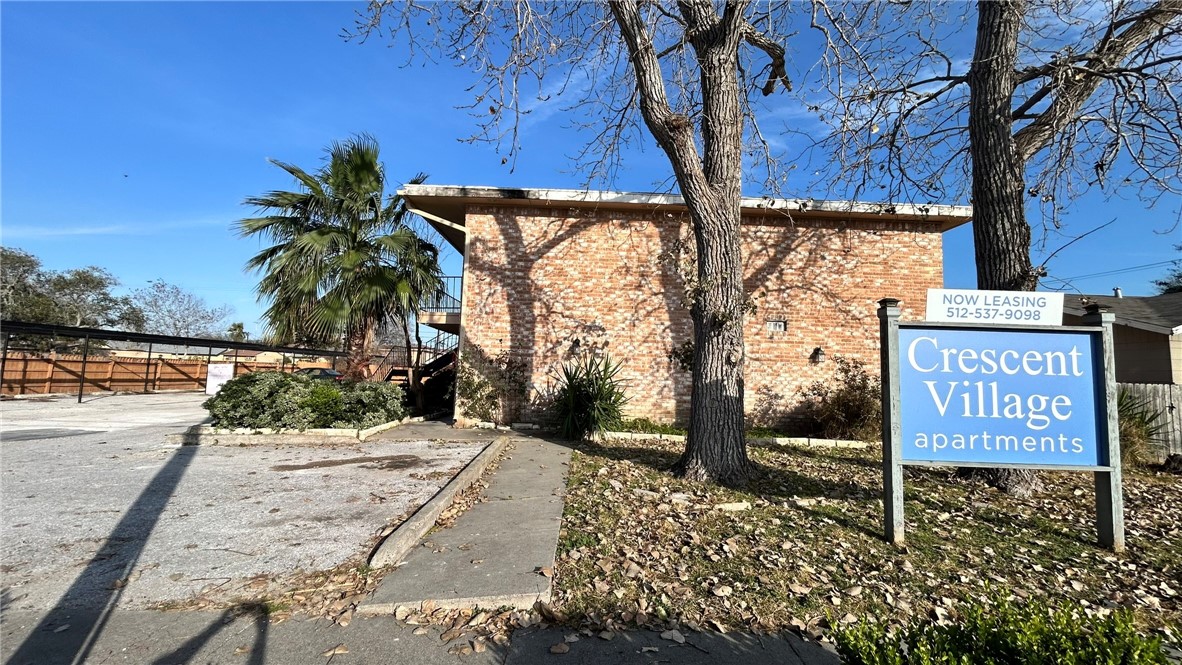 1004 Austin Street, Unit 2 Portland, TX 78374 - Photo 2 of 22 a view of a street with sign board