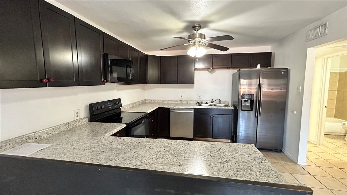 1004 Austin Street, Unit 2 Portland, TX 78374 - Photo 4 of 22 a kitchen with stainless steel appliances granite countertop a sink