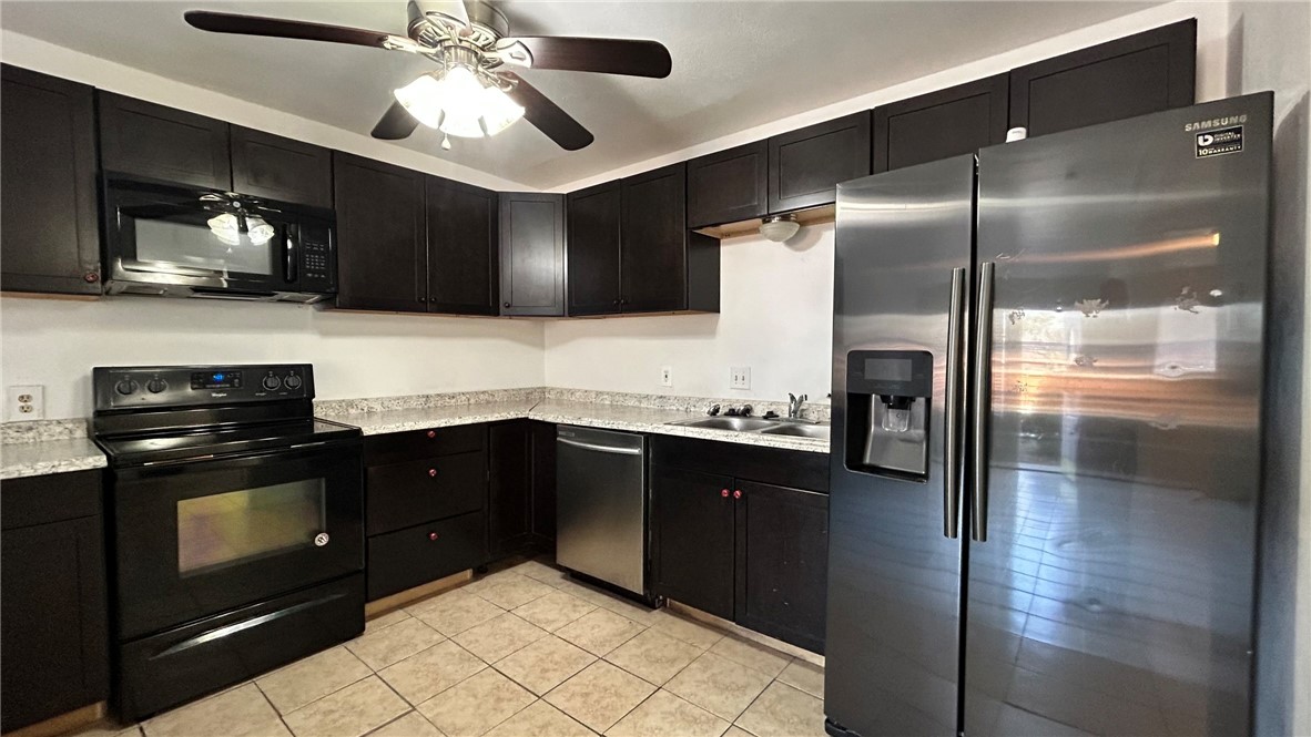 1004 Austin Street, Unit 2 Portland, TX 78374 - Photo 5 of 22 a kitchen with a refrigerator and a sink