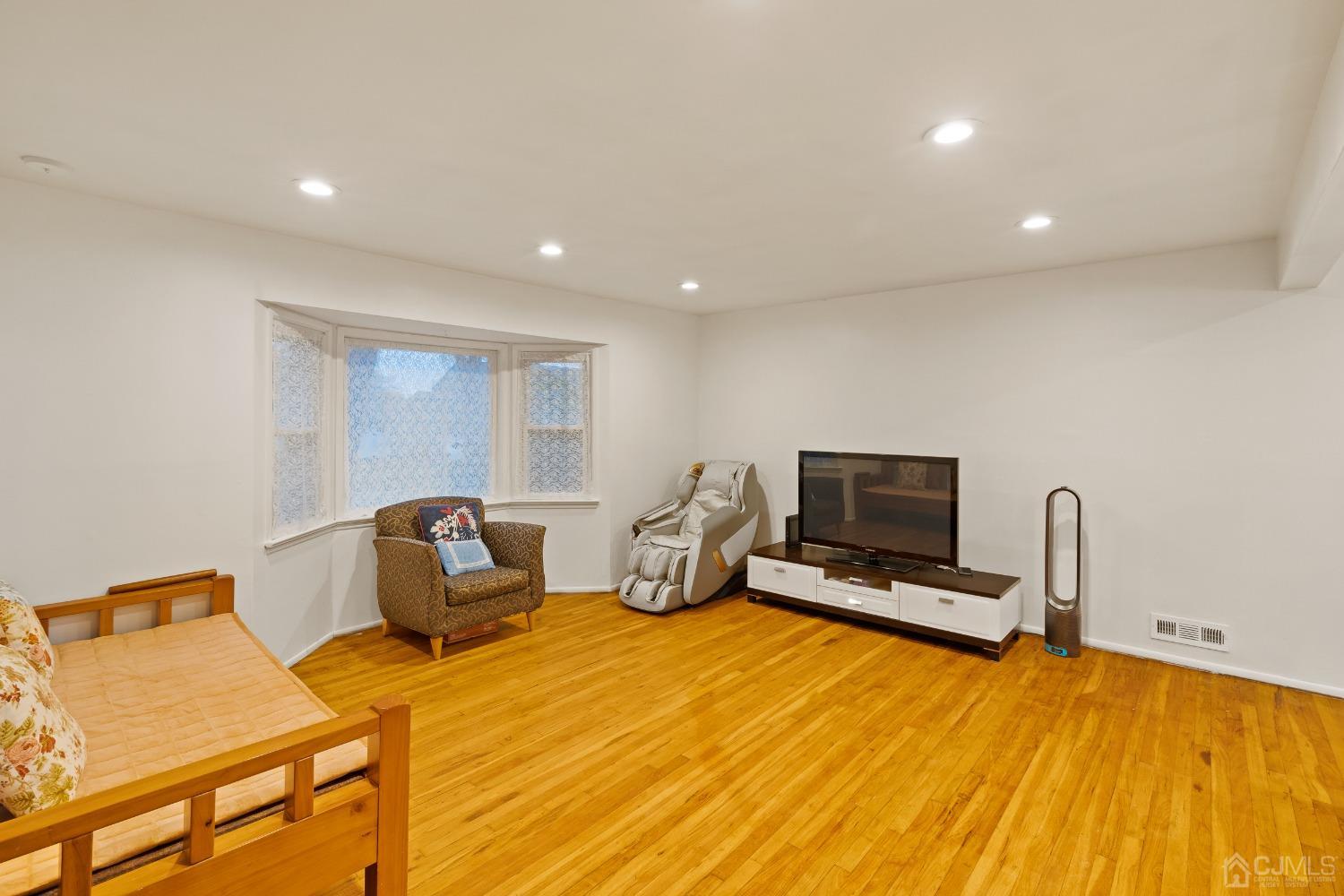 12 Meyer Road Edison, NJ 08817 - Photo 6 of 21 a bedroom with a bed a flat screen tv and dresser
