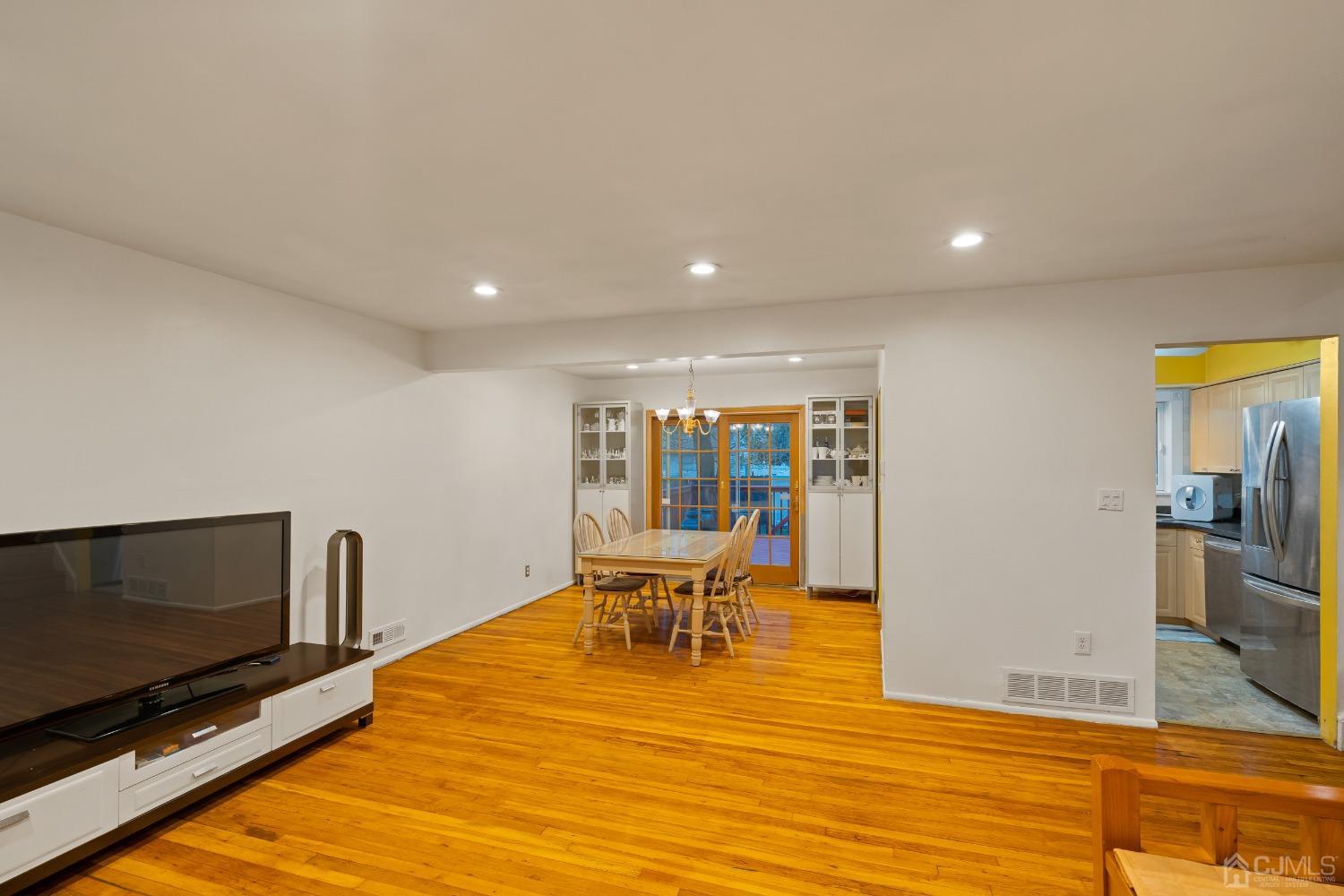 12 Meyer Road Edison, NJ 08817 - Photo 7 of 21 a view of a living room a dining room with furniture and wooden floor