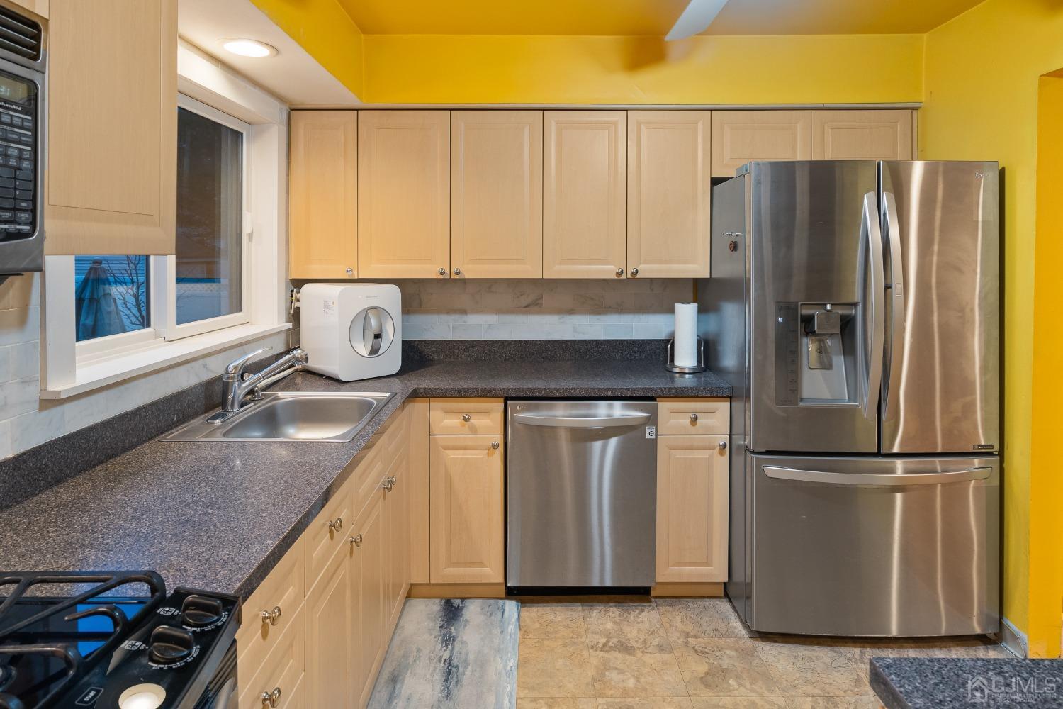 12 Meyer Road Edison, NJ 08817 - Photo 9 of 21 a kitchen with granite countertop a refrigerator and a sink