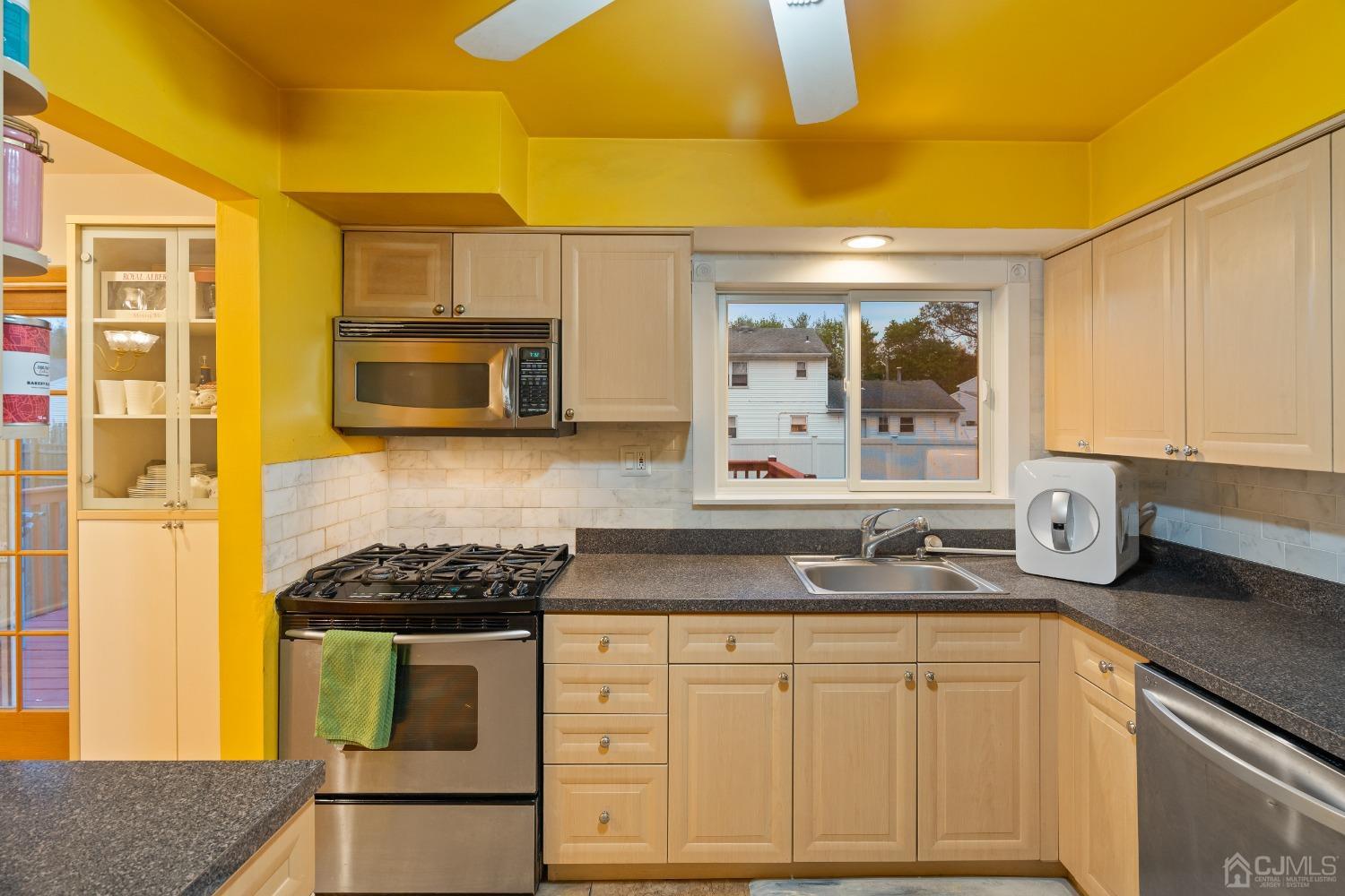 12 Meyer Road Edison, NJ 08817 - Photo 10 of 21 a kitchen with a stove a sink and a microwave