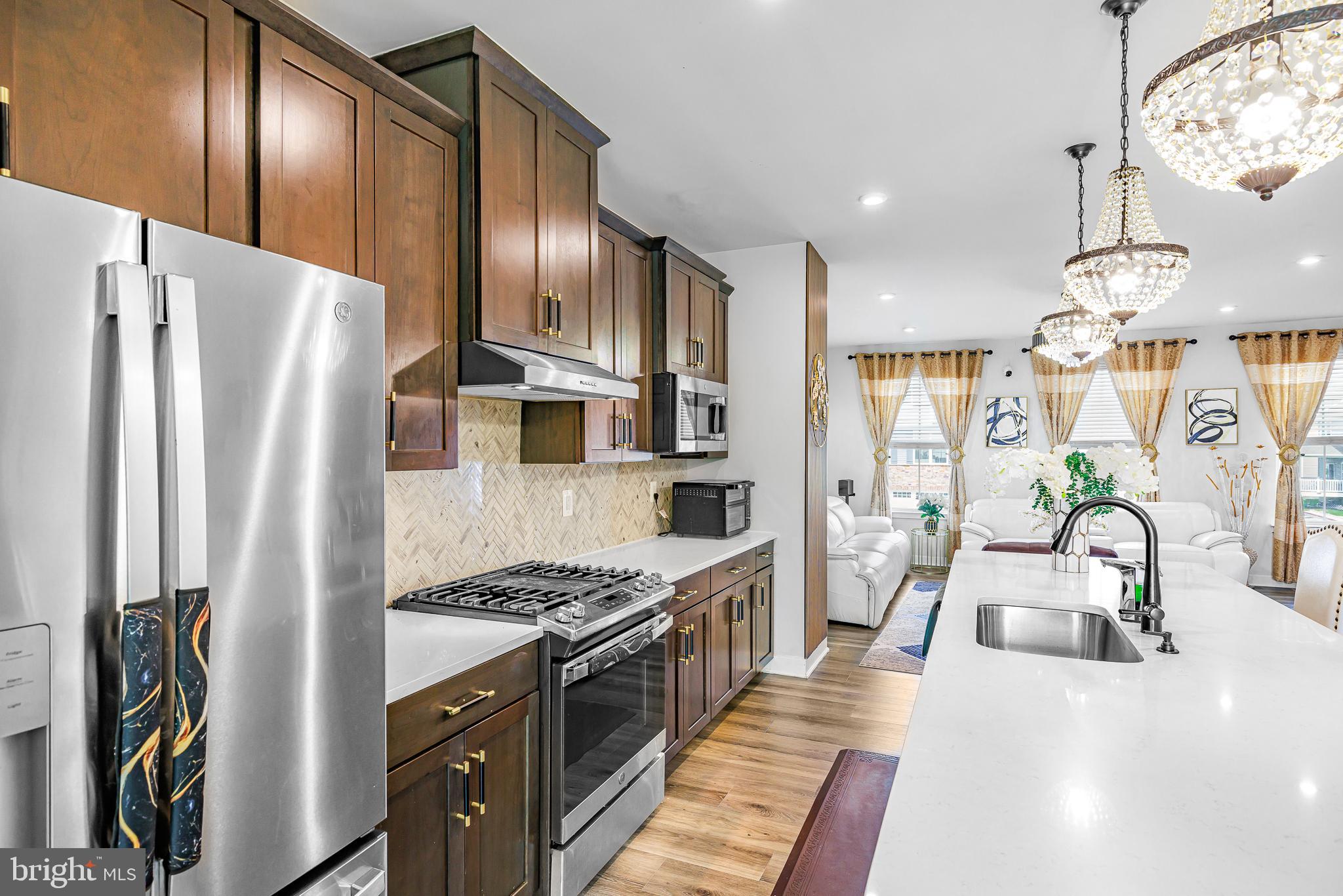 109 Torrey Drive Newark, DE 19702 - Photo 15 of 49 a kitchen with stainless steel appliances granite countertop a refrigerator a oven a sink and a stove