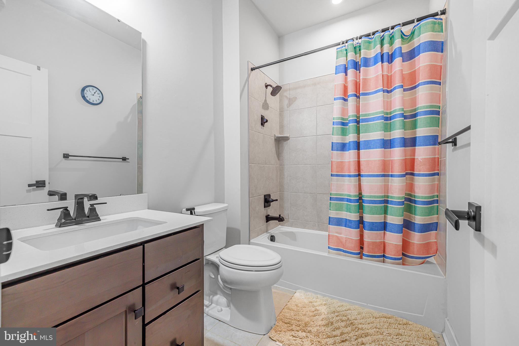 109 Torrey Drive Newark, DE 19702 - Photo 36 of 49 a bathroom with a sink a toilet and shower curtain