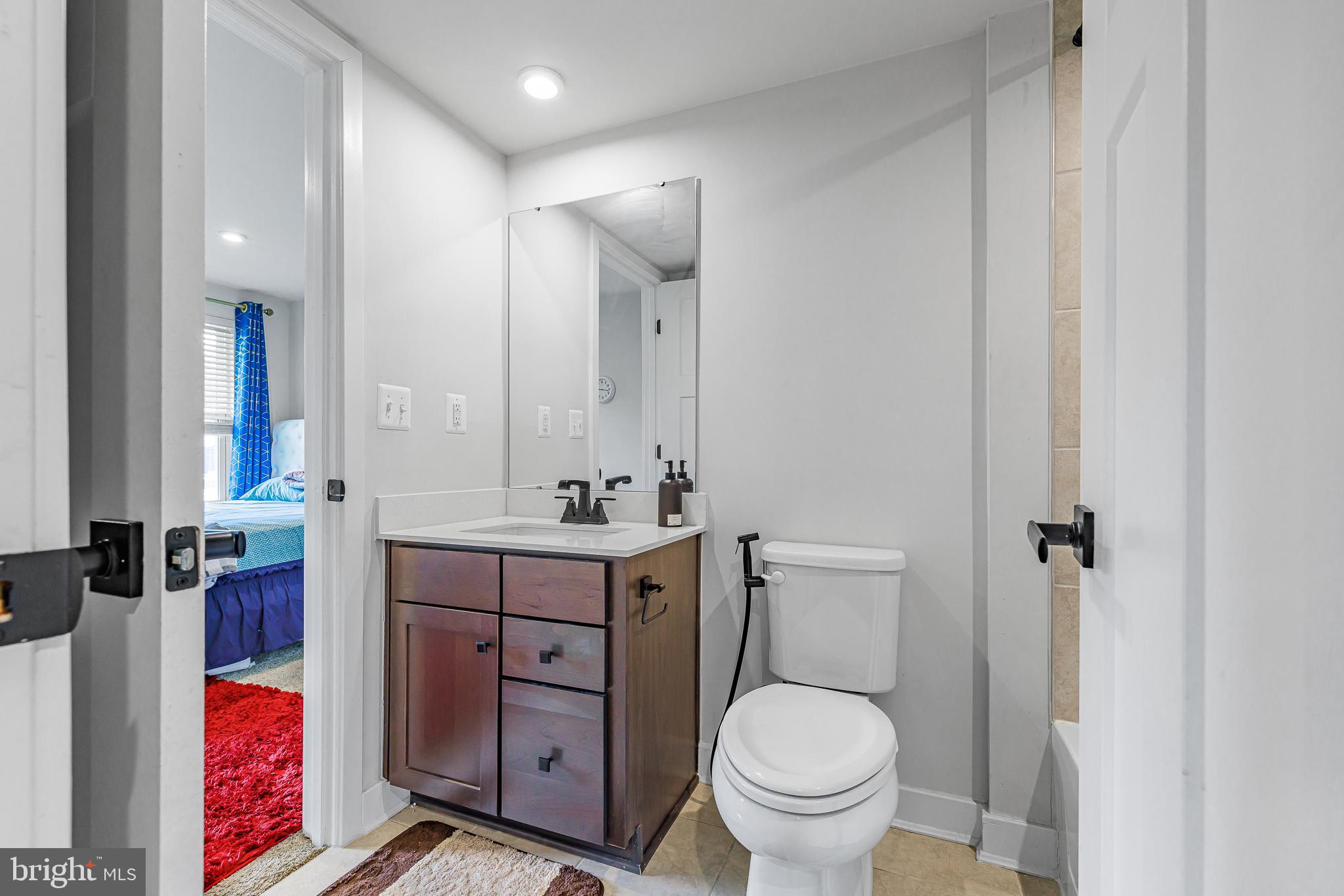 109 Torrey Drive Newark, DE 19702 - Photo 9 of 49 a bathroom with a toilet sink and mirror