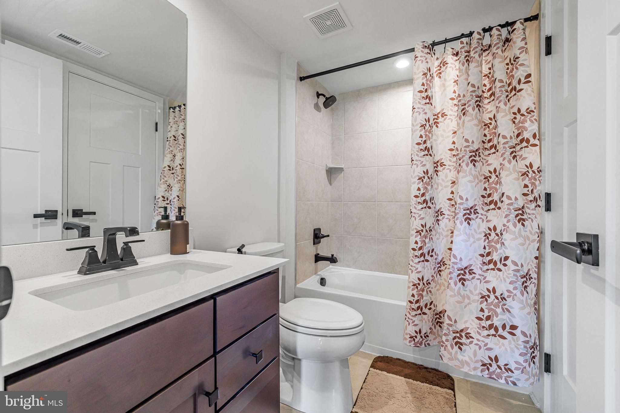 109 Torrey Drive Newark, DE 19702 - Photo 10 of 49 a bathroom with a sink toilet a shower and a mirror