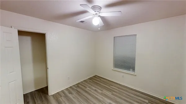 a view of room with window and ceiling fan