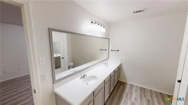 a bathroom with a sink a mirror and shower