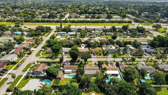 an aerial view of residential building with parking
