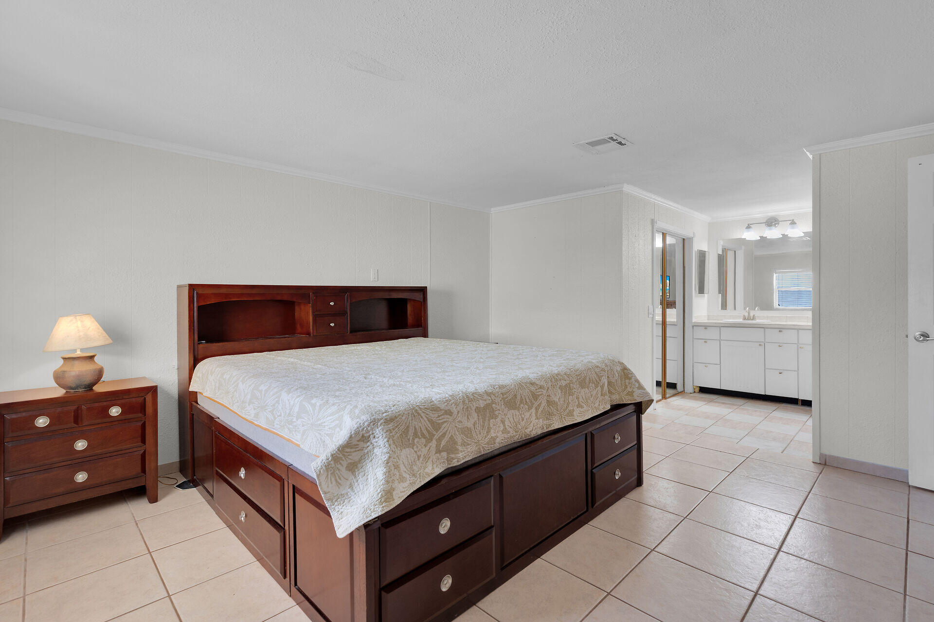 144 Sunset Lane Tavernier, FL 33070 - Photo 12 of 49 a bedroom with a bed and a cabinets