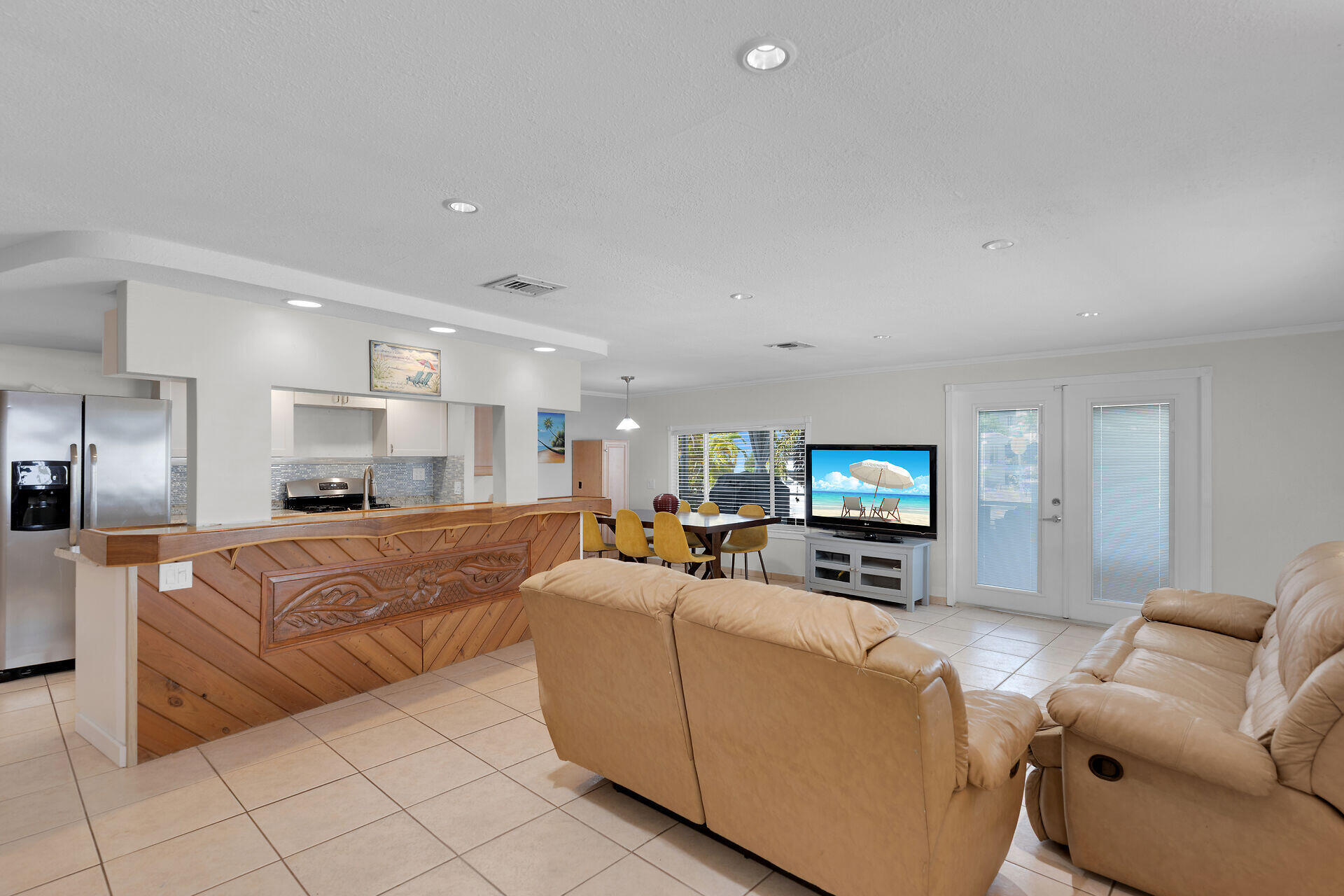 144 Sunset Lane Tavernier, FL 33070 - Photo 14 of 49 a living room with furniture a flat screen tv and a fireplace