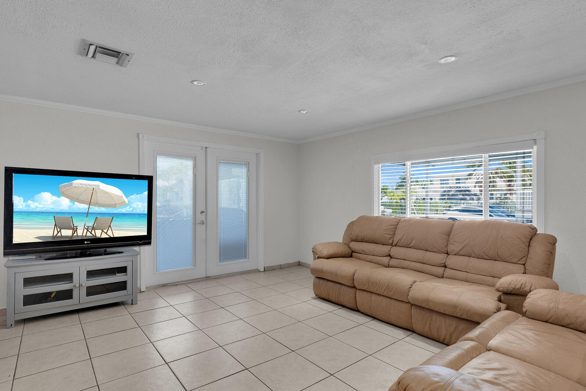 144 Sunset Lane Tavernier, FL 33070 - Photo 15 of 49 a living room with furniture and a flat screen tv