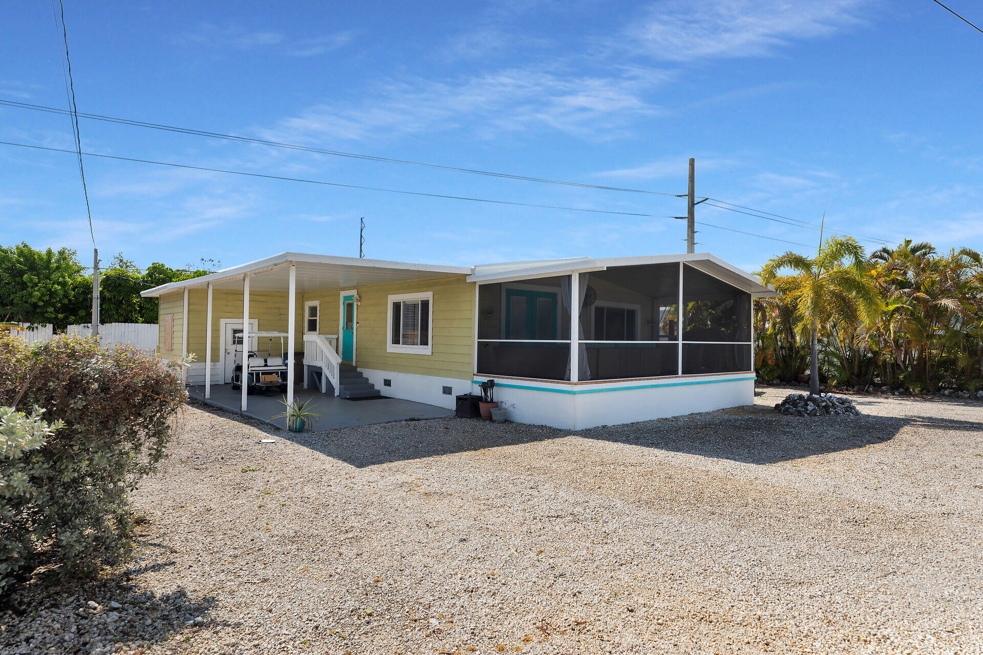144 Sunset Lane Tavernier, FL 33070 - Photo 2 of 49 a front view of a house with garden and porch
