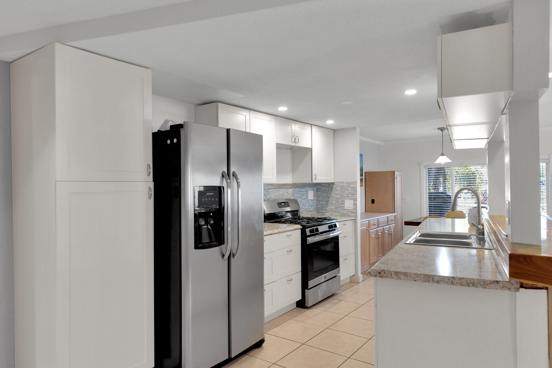 144 Sunset Lane Tavernier, FL 33070 - Photo 22 of 49 a kitchen with stainless steel appliances granite countertop a refrigerator a stove and a sink