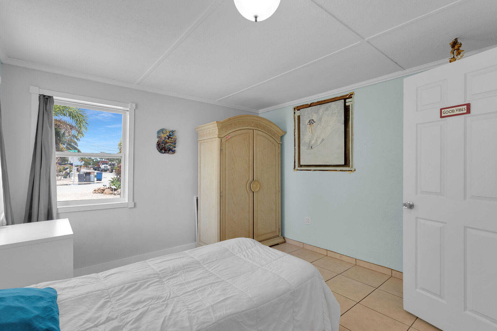 144 Sunset Lane Tavernier, FL 33070 - Photo 24 of 49 a bedroom with a bed and a window