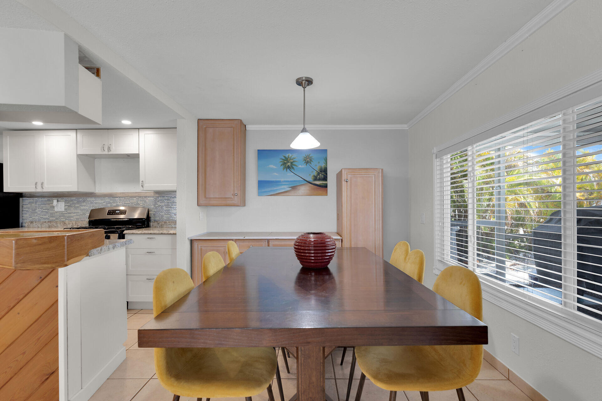 144 Sunset Lane Tavernier, FL 33070 - Photo 39 of 49 a kitchen with a dining table chairs and chandelier