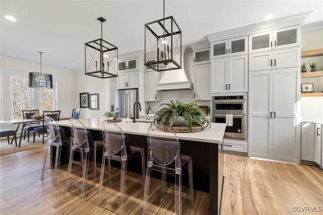 a view of kitchen with dining area refrigerator and wooden floor