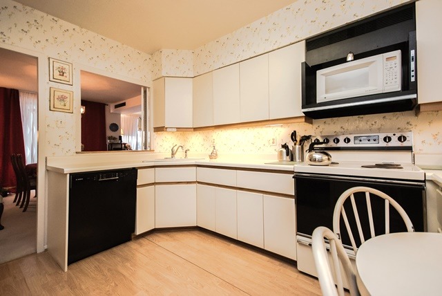 1616 Sheridan Road, Unit 4H Wilmette, IL 60091 - Photo 8 of 16 a kitchen with a sink a stove and cabinets