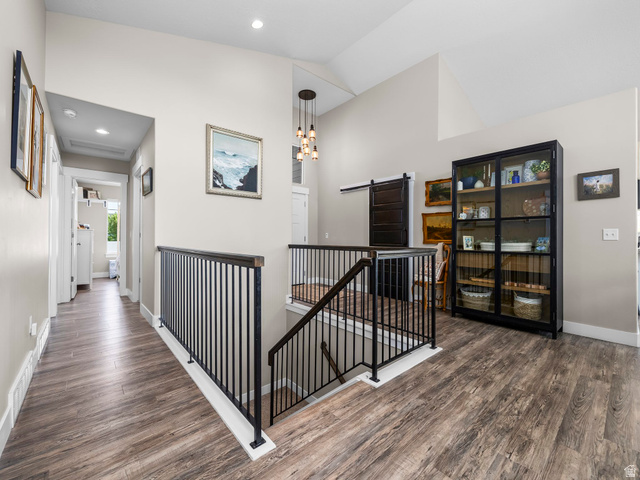 7 Sterling Loop Vineyard, UT 84059 - Photo 8 of 43 Expansive upper-level landing featuring wood-finish flooring, a modern black iron railing, and vaulted ceilings
