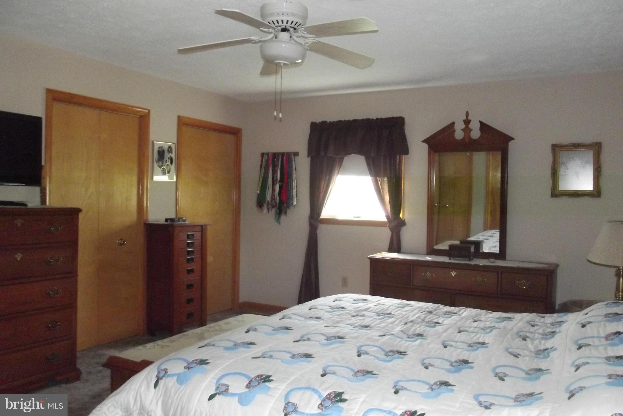 863 Pheasant Hill Road Summit Point, WV 25446 - Photo 8 of 29 a bedroom with a bed and a dresser