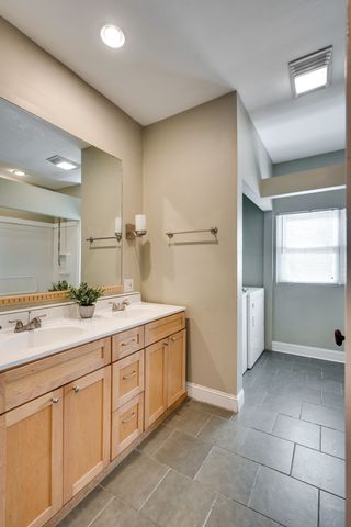 a bathroom with a double vanity sink a mirror and a