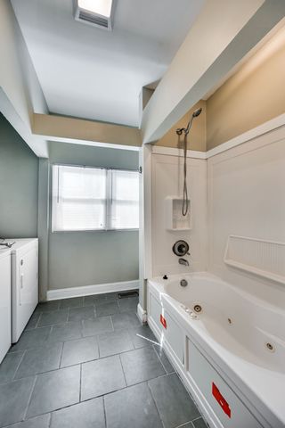 a bathroom with a bathtub and a shower