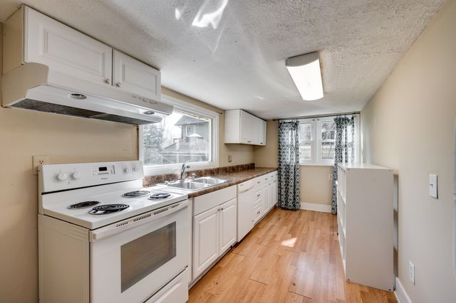 a kitchen that has a stove and a microwave