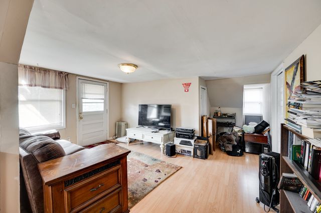 a room with furniture a flat screen tv and a window