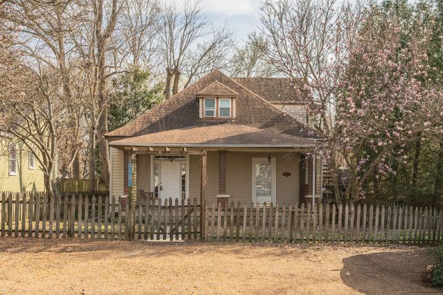 a front view of a house with a fence