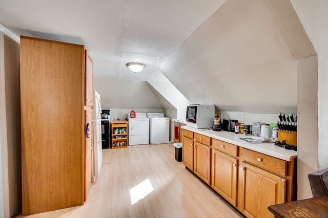 a kitchen with stainless steel appliances granite countertop a refrigerator and wooden floor