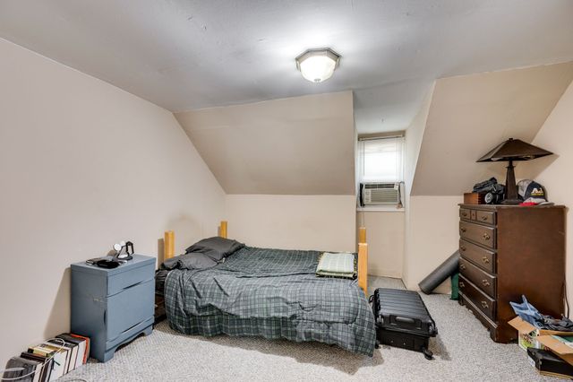 a bedroom with a bed and a chair