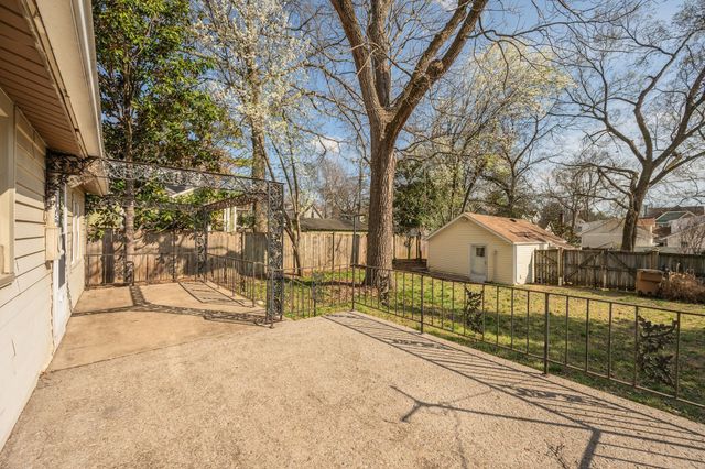 a view of a house with a yard covered in snow